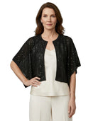 Woman wearing a black sequined jacket over a white top and pants on a white background