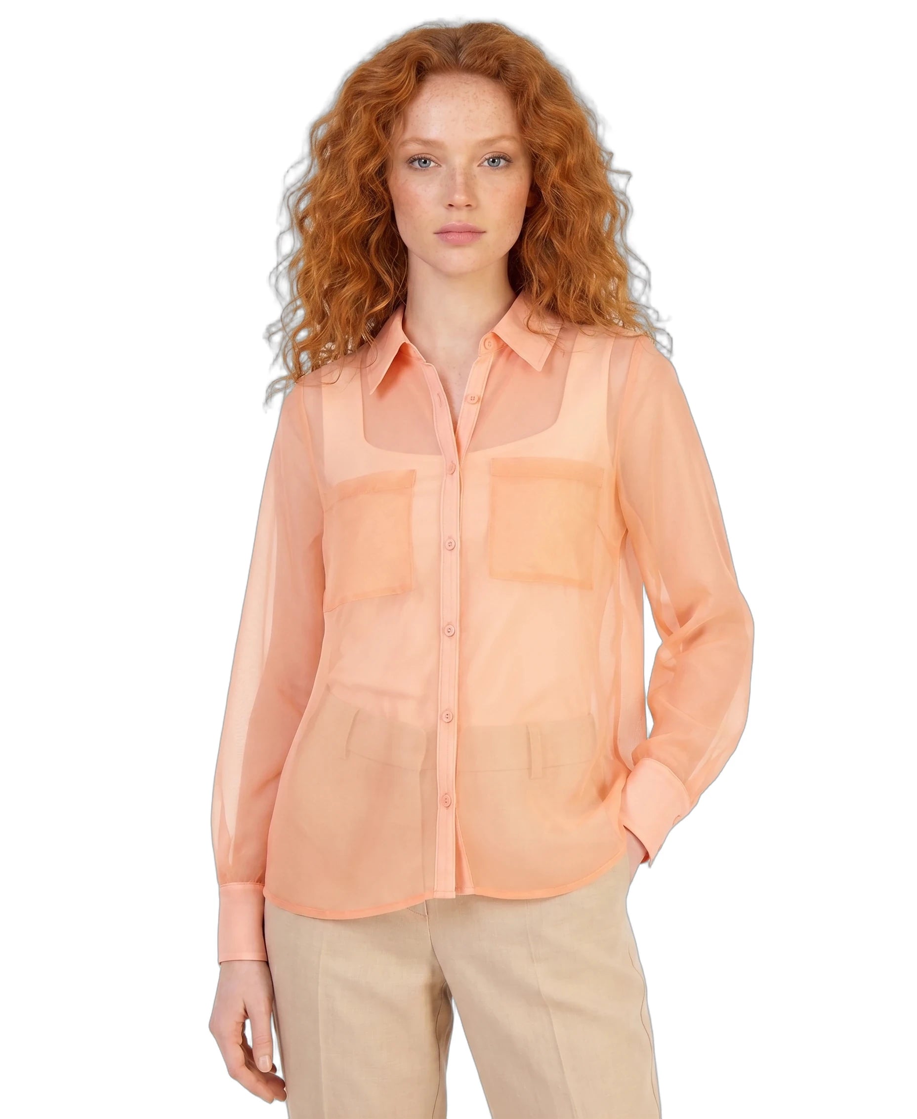 Woman wearing a peach sheer blouse on a white background