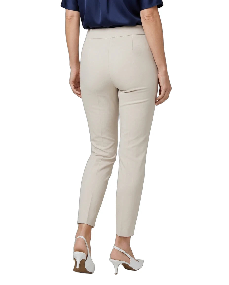 A model shown from the back wearing high-waisted, light beige cropped trousers, a navy blue top, and white slingback heels against a plain white background.