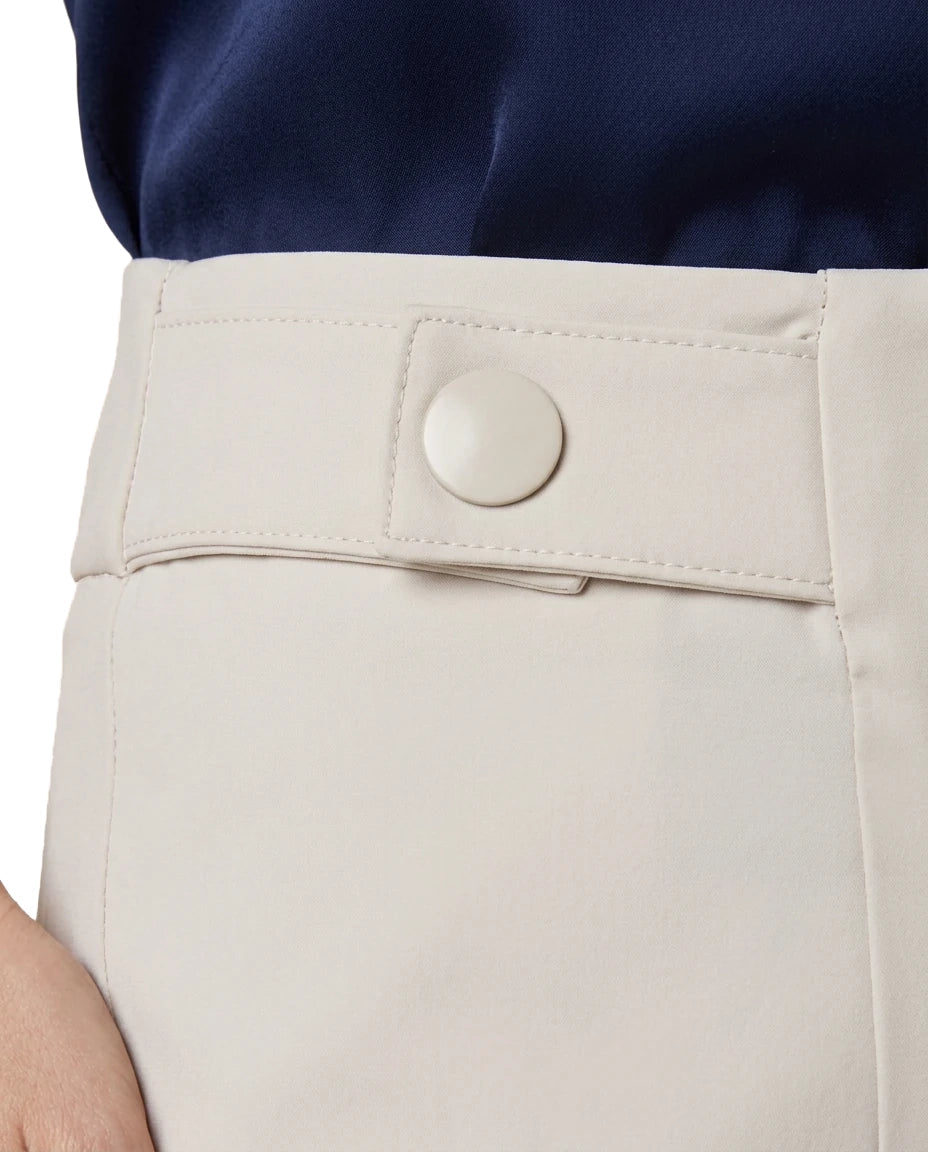 Close-up of a person wearing light beige trousers with a buttoned waistband and a navy top, cropped to show the waist area.