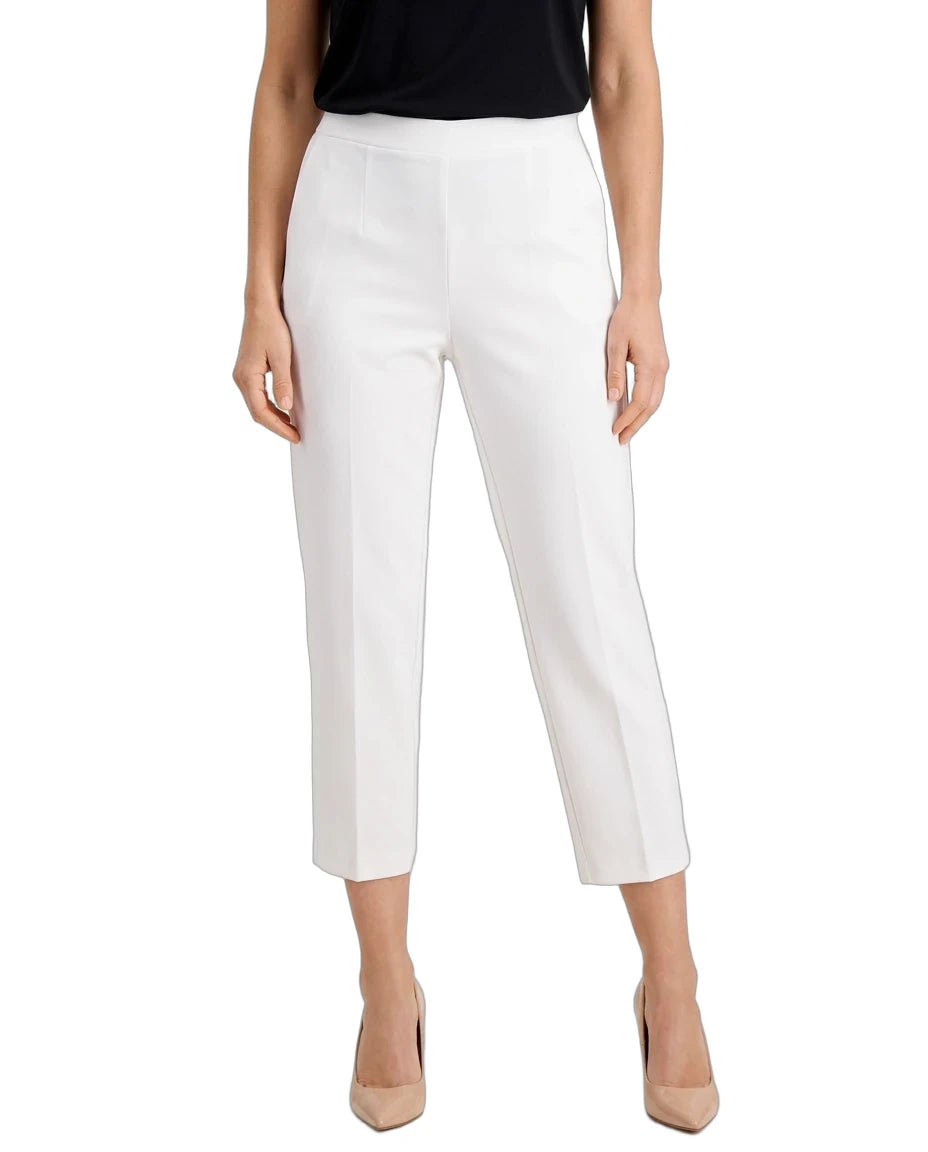 White cropped ankle-length pants shown on a model against a plain white studio background. The model is also wearing a black top and beige heels.