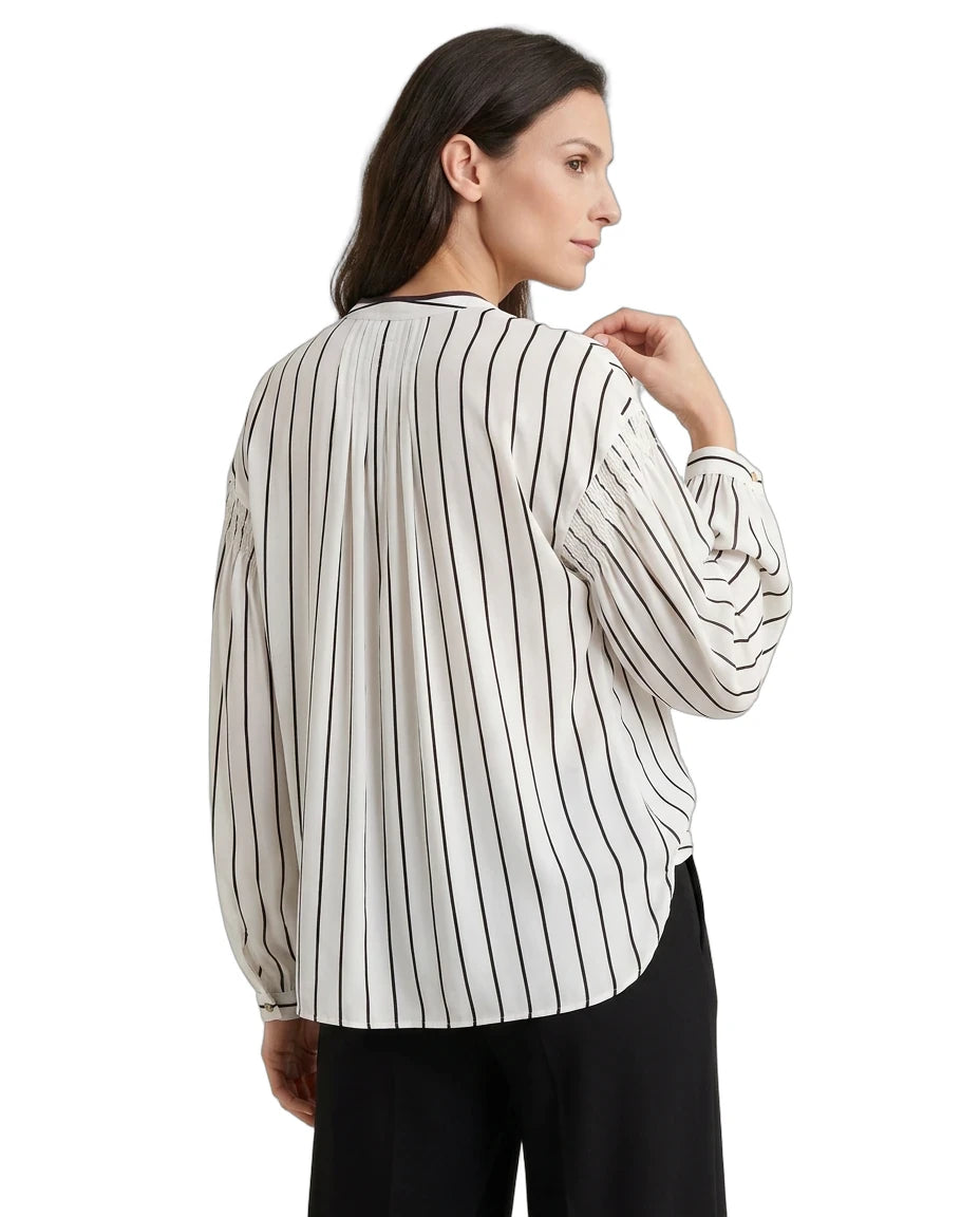 Woman wearing a striped blouse with long sleeves on a white background