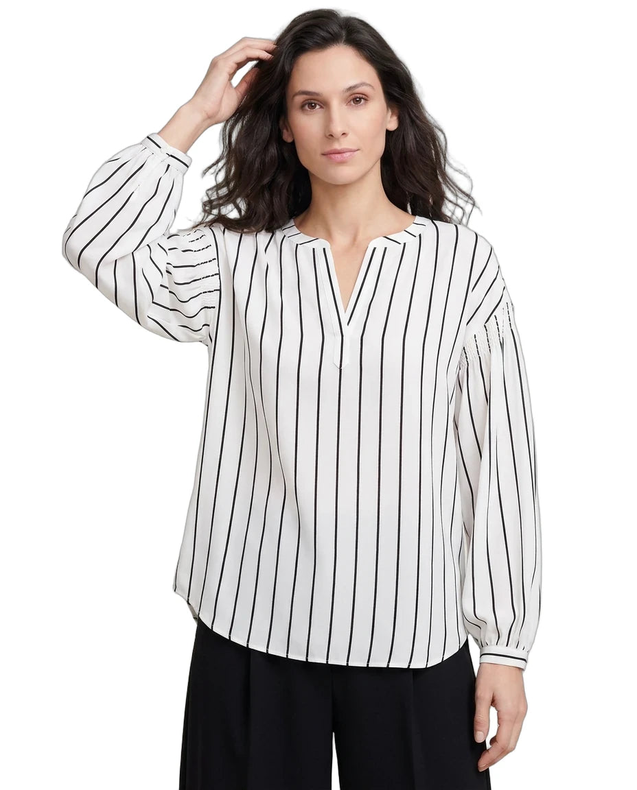 Woman wearing a black and white striped shirt on a white background