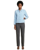 A woman modeling a light blue textured long-sleeve button-up shirt paired with dark gray straight-leg trousers and brown strappy sandals, set against a plain white background.