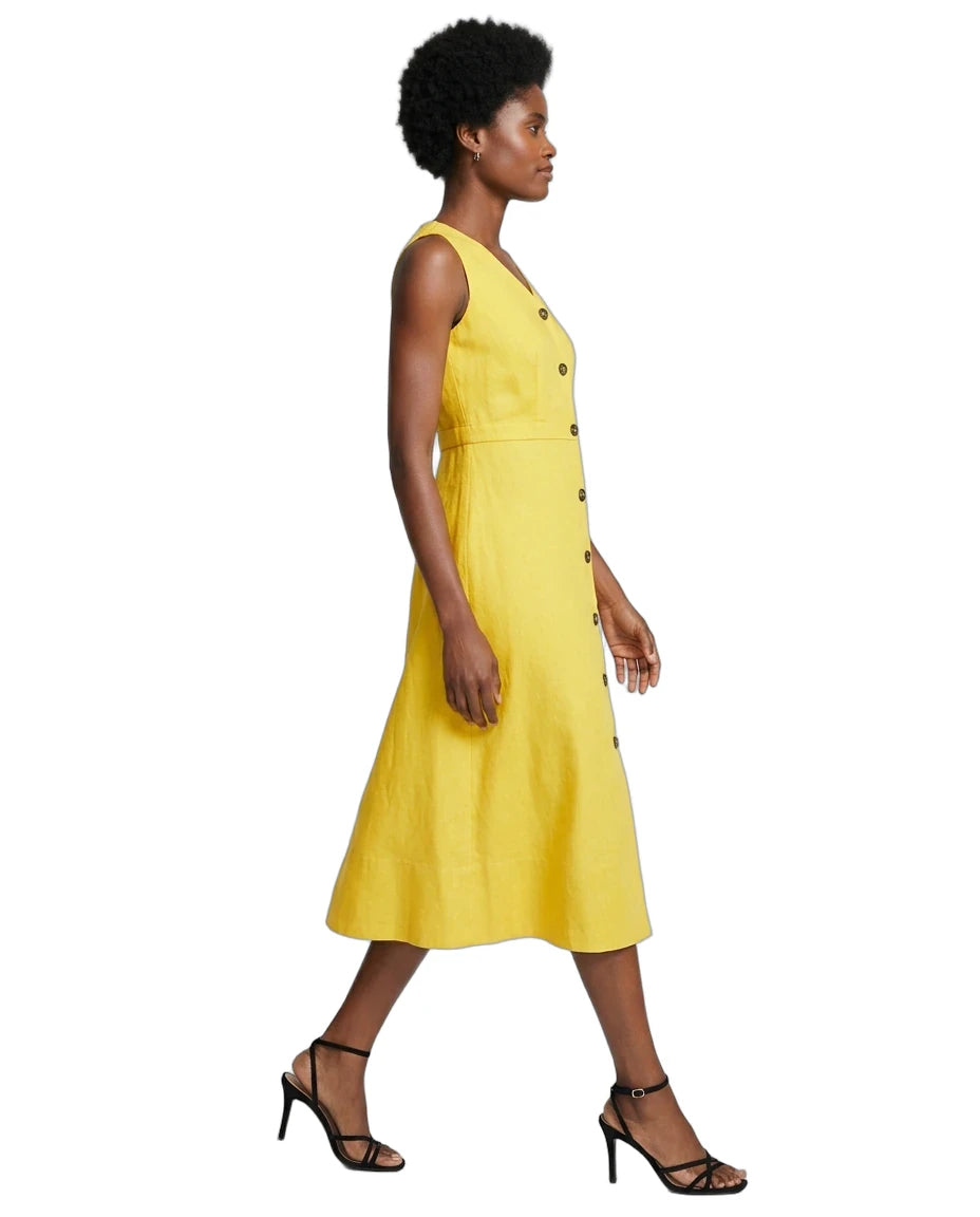 A woman modeling a sleeveless yellow midi dress with a button-down front, shown in profile against a plain white background.