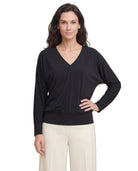 Woman wearing a black long-sleeve top on a white background