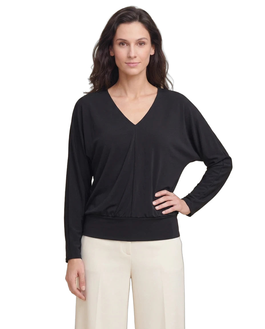 Woman wearing a black long-sleeve top on a white background