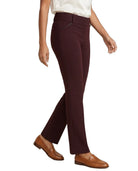 A model wearing a pair of dark burgundy flared trousers, styled with a white top and brown leather loafers, shown from the waist down against a plain white background.