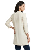 Woman wearing a beige cardigan on a white background