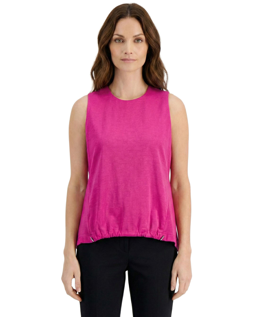 Woman wearing a bright pink sleeveless top on a white background