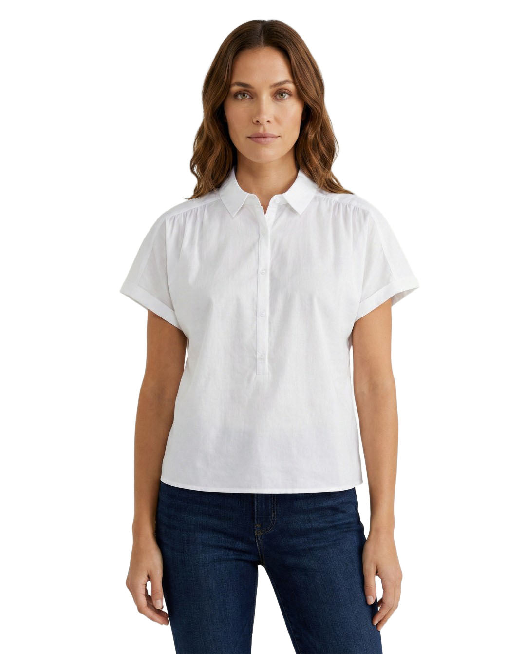 Woman wearing a white short-sleeve blouse and dark jeans on a white background
