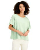 Woman wearing a light green blouse on a white background