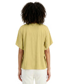 Person wearing a light green t-shirt and white pants on a white background