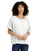 Woman wearing a white oversized t-shirt and blue jeans on a white background