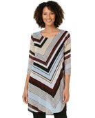 Woman wearing a long, patterned dress with a white background