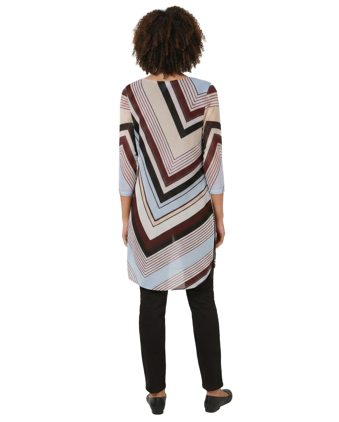 Person wearing a patterned tunic with a white background