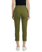 Person wearing olive green pants on a white background