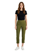 Woman wearing a black t-shirt and green pants on a white background