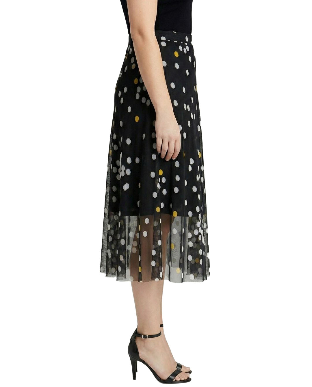 Black tulle skirt with white polka dots worn by a person on a white background