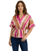Woman wearing a colorful striped blouse on a white background