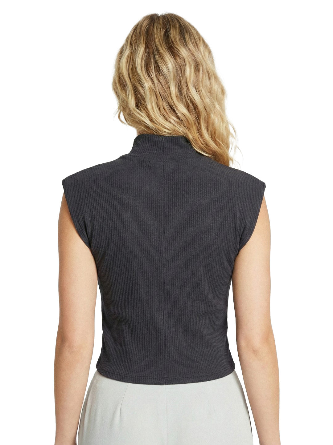 Person wearing a dark gray sleeveless top on a white background