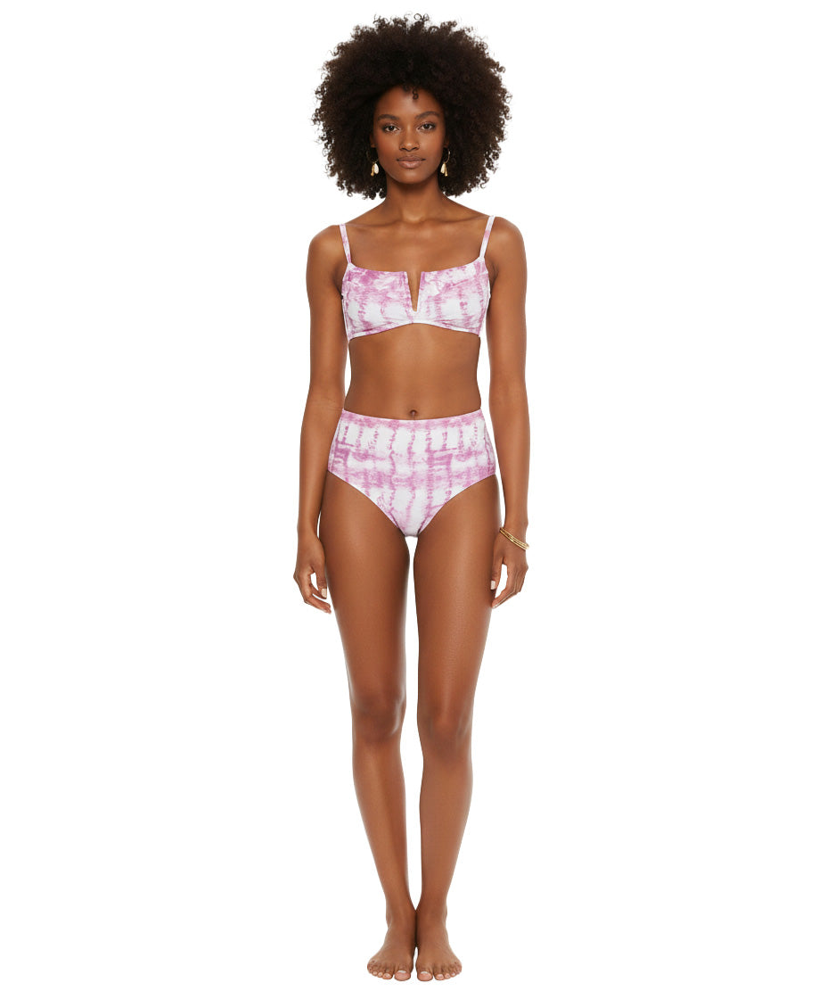 Woman wearing a pink tie-dye bikini set on a white background