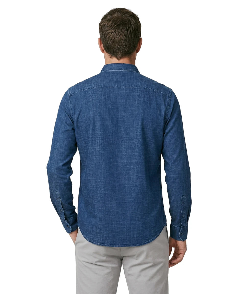 Man wearing a blue patterned shirt on a white background
