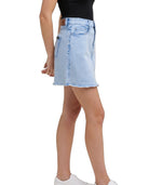Light blue denim skirt worn by a person on a white background