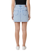 Light blue denim skirt worn by a person on a white background