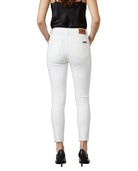 Person wearing white pants with a black top on a white background