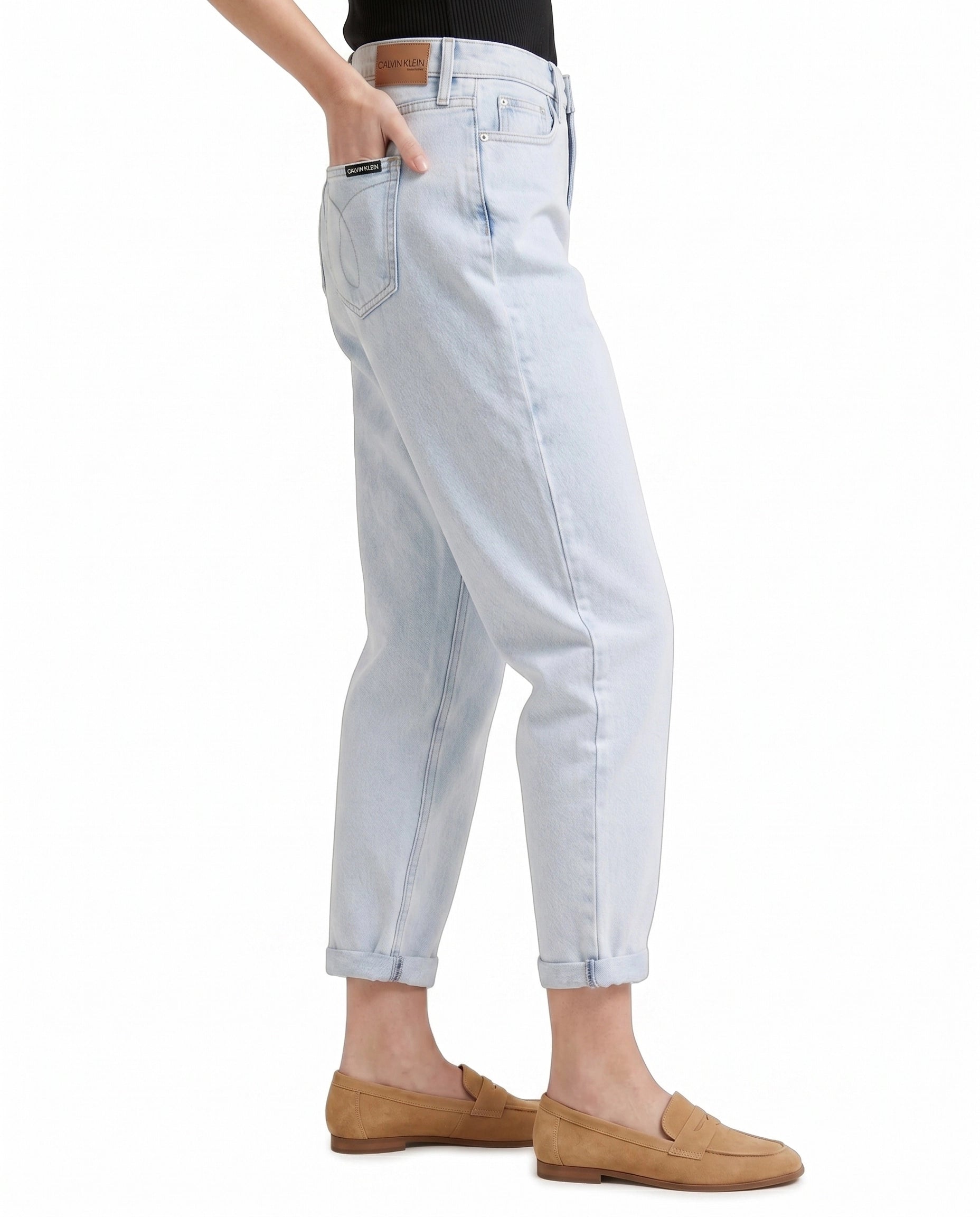 Light blue Calvin Klein jeans worn by a person on a white background