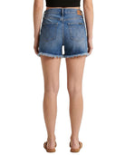 Denim shorts worn by a person on a white background