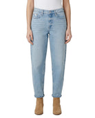 Light Calvin Klein blue jeans worn by a person on a white background