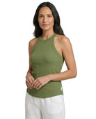 Woman wearing a green ribbed tank top on a white background