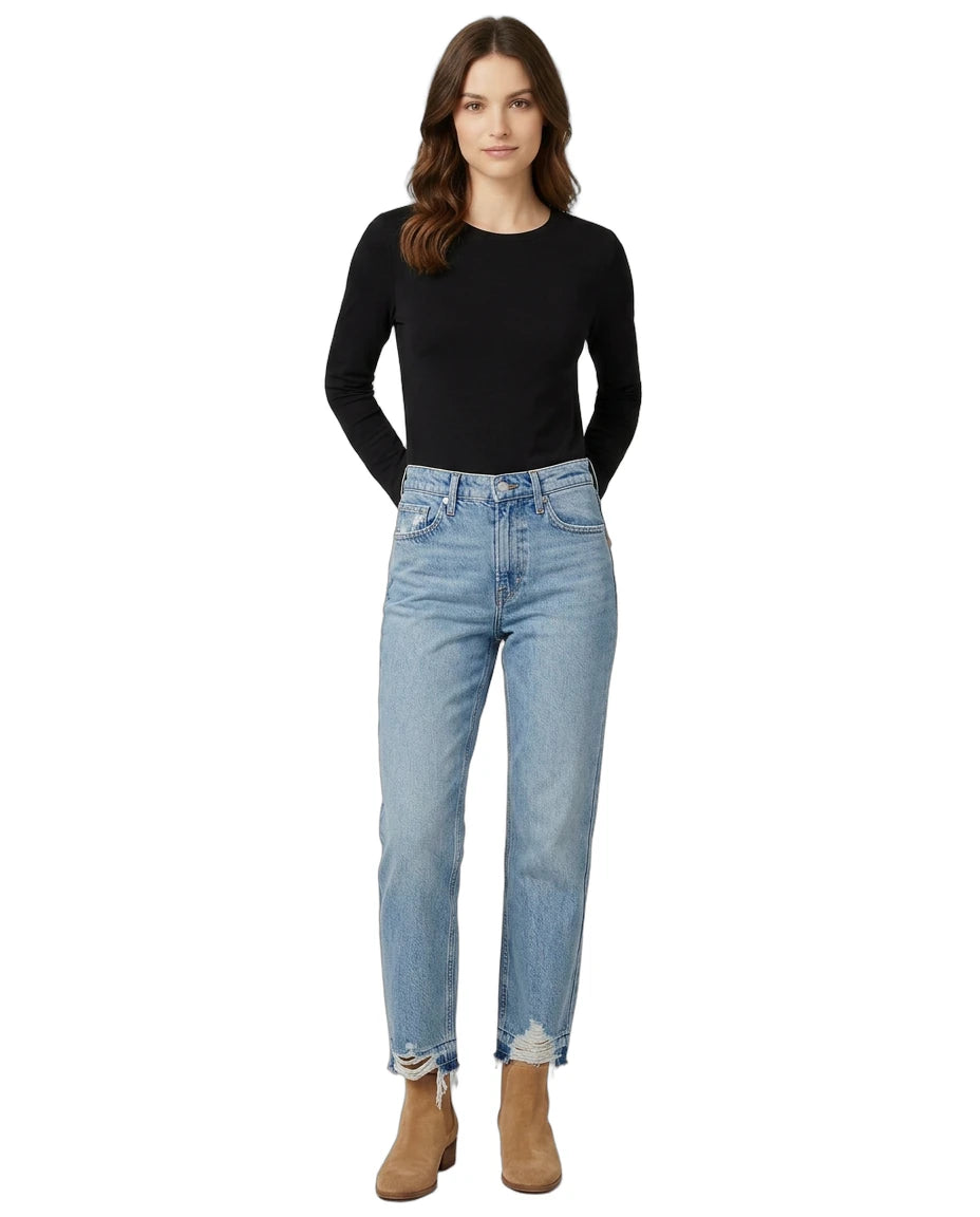 Woman wearing a black top and light blue jeans on a white background