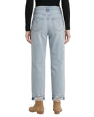 Light blue jeans worn by a person on a white background