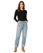 Woman wearing a black top and light blue jeans on a white background