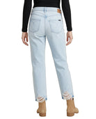 Light blue jeans with distressed hem worn by a person on a white background