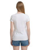 Person wearing a plain white t-shirt and denim shorts on a white background