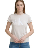 Woman wearing a beige t-shirt with a logo on a white background
