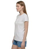 Woman wearing a white t-shirt with a logo on a white background