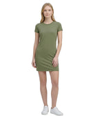 Woman wearing a green Calvin Klein dress on a white background
