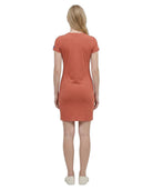 Woman wearing a rust-colored Calvin Klein dress on a white background