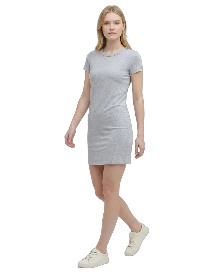 Woman wearing a gray Calvin Klein t-shirt dress on a white background