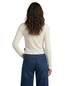 Person wearing a cream sweater and blue jeans on a white background