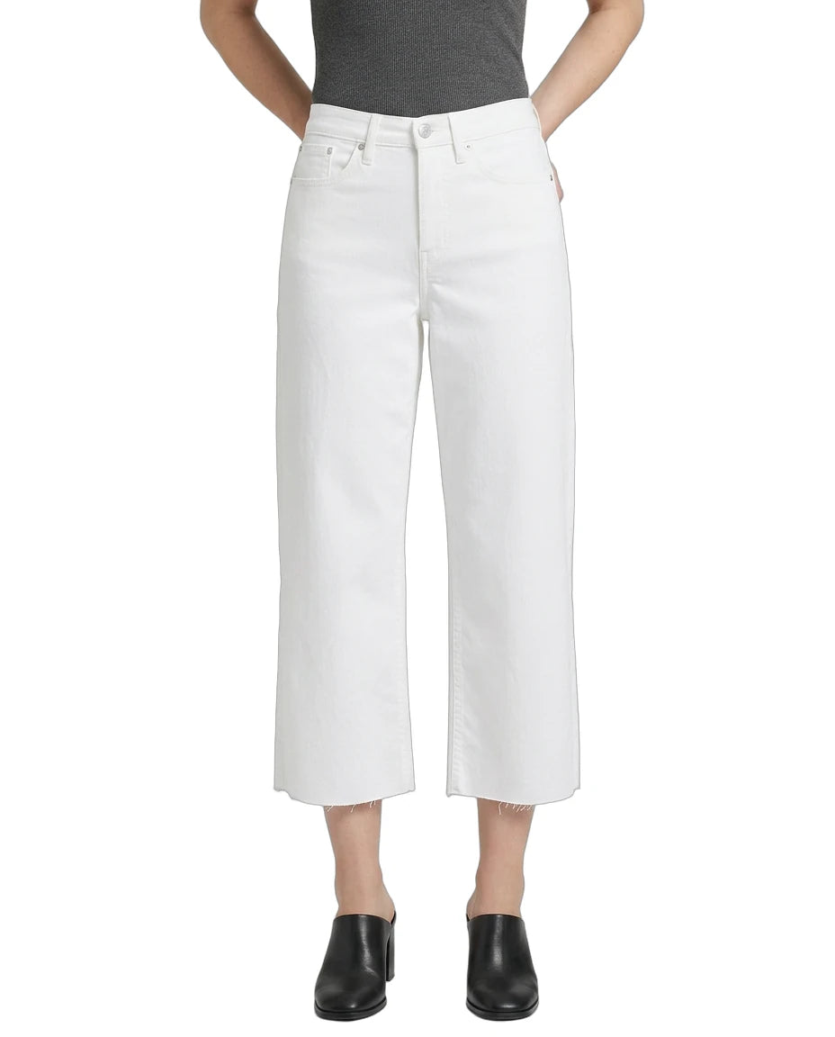 Person wearing white wide-leg jeans on a white background