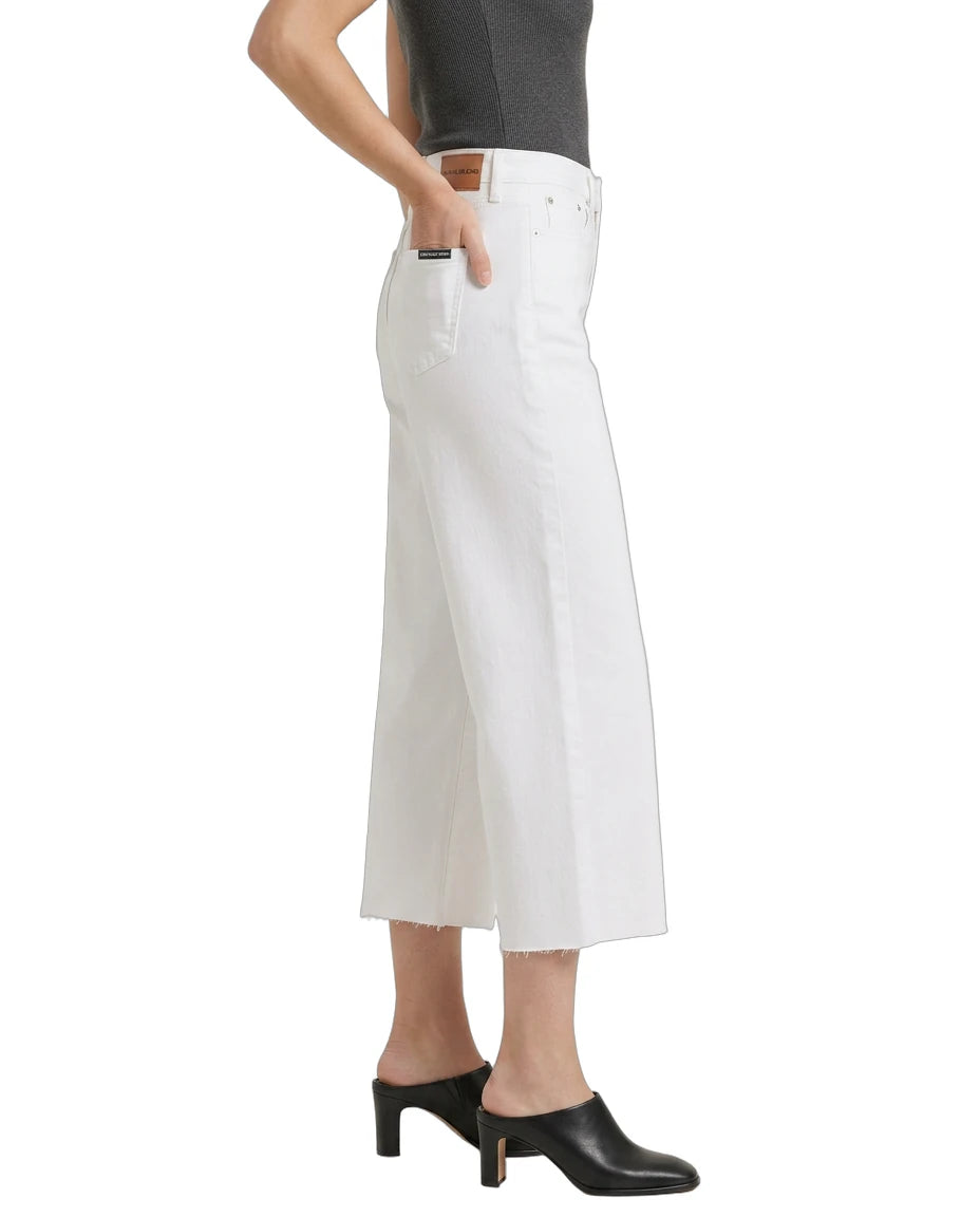 White wide-leg jeans worn by a person on a white background