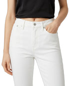 Person wearing white jeans and a black top on a plain background