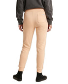 Person wearing beige jogger pants and a gray sweatshirt on a white background