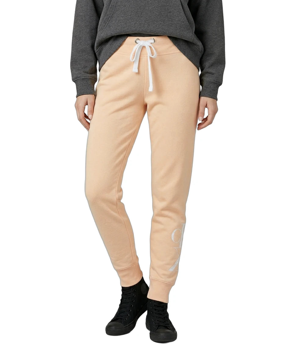 Person wearing beige jogger pants with a gray sweatshirt on a white background